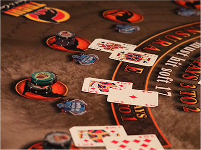 3 pairs of cards accompanied by chips in a game of poker