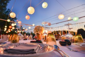 Outdoor table setting for a  wedding venue with lantern lights at night