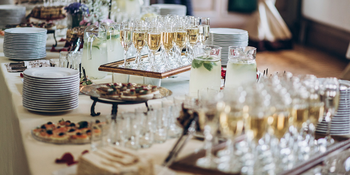 A table catered with champagne and cookies